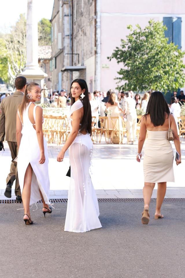 Dua Lipa wore a sheer white dress with a bandeau bra and thigh-high slit to  a wedding in France - Yahoo Sports