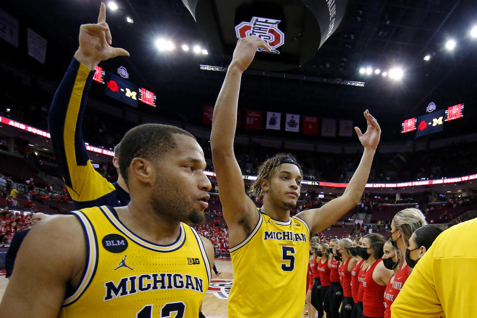 Mar 6, 2022; Columbus, Ohio, USA;  Michigan Wolverines forward Terrance Williams II (5) and guard DeVante' Jones (12) celebrate following the win against the Ohio State Buckeyes at Value City Arena. Mandatory Credit: Joseph Maiorana-USA TODAY Sports