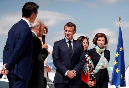 French President Emmanuel Macron, Eric Trappier, Chairman and CEO of Dassault Aviation, Dirk Hoke, CEO of Airbus Defence and Space, attend the unveiling of the New Generation Fighter (NGF) model during a visit the 53rd International Paris A