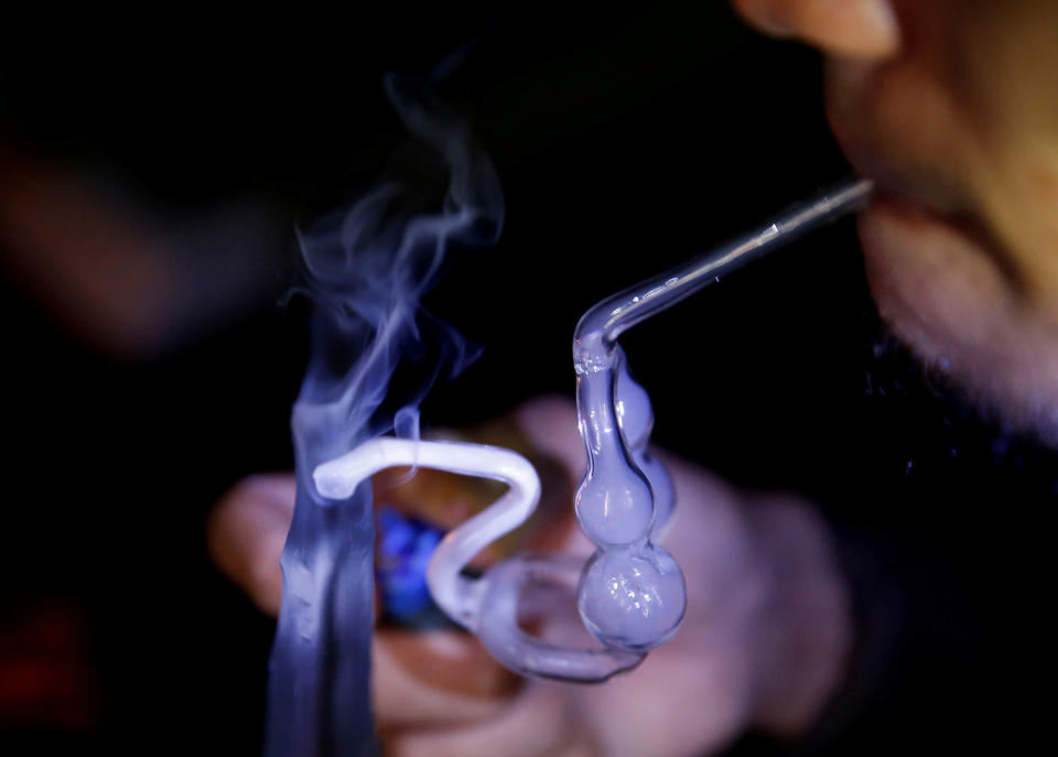 <p>A drug addict uses a glass water pipe to smoke shabu, or methamphetamine, at an undisclosed drug den in Manila, Philippines on June 20, 2016. (REUTERS/Staff) </p>