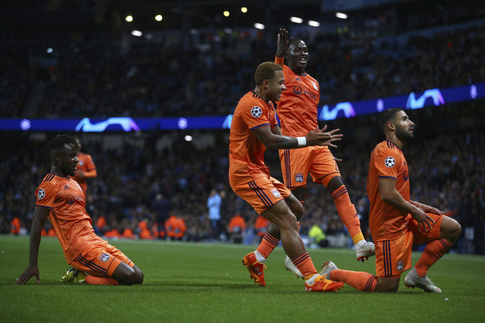 Lyon's Nabil Fekir, right, celebrates after scoring his sides second goal during the Champions League Group F soccer match between Manchester City and Lyon at the Etihad stadium in Manchester, England, Wednesday, Sept. 19, 2018. (AP Photo/Dave Thompson)