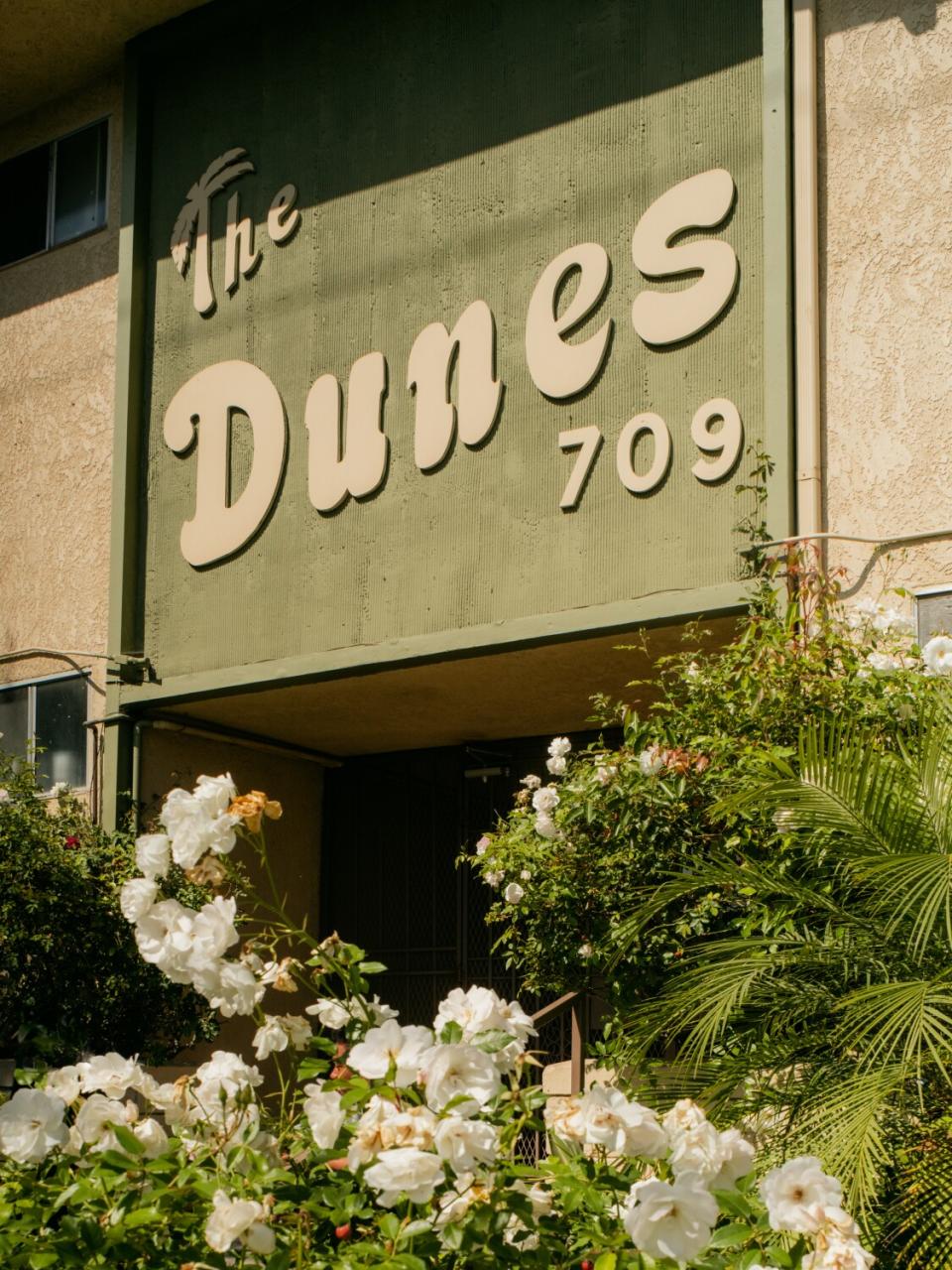 Apartment building sign that reads "The Dunes 709."