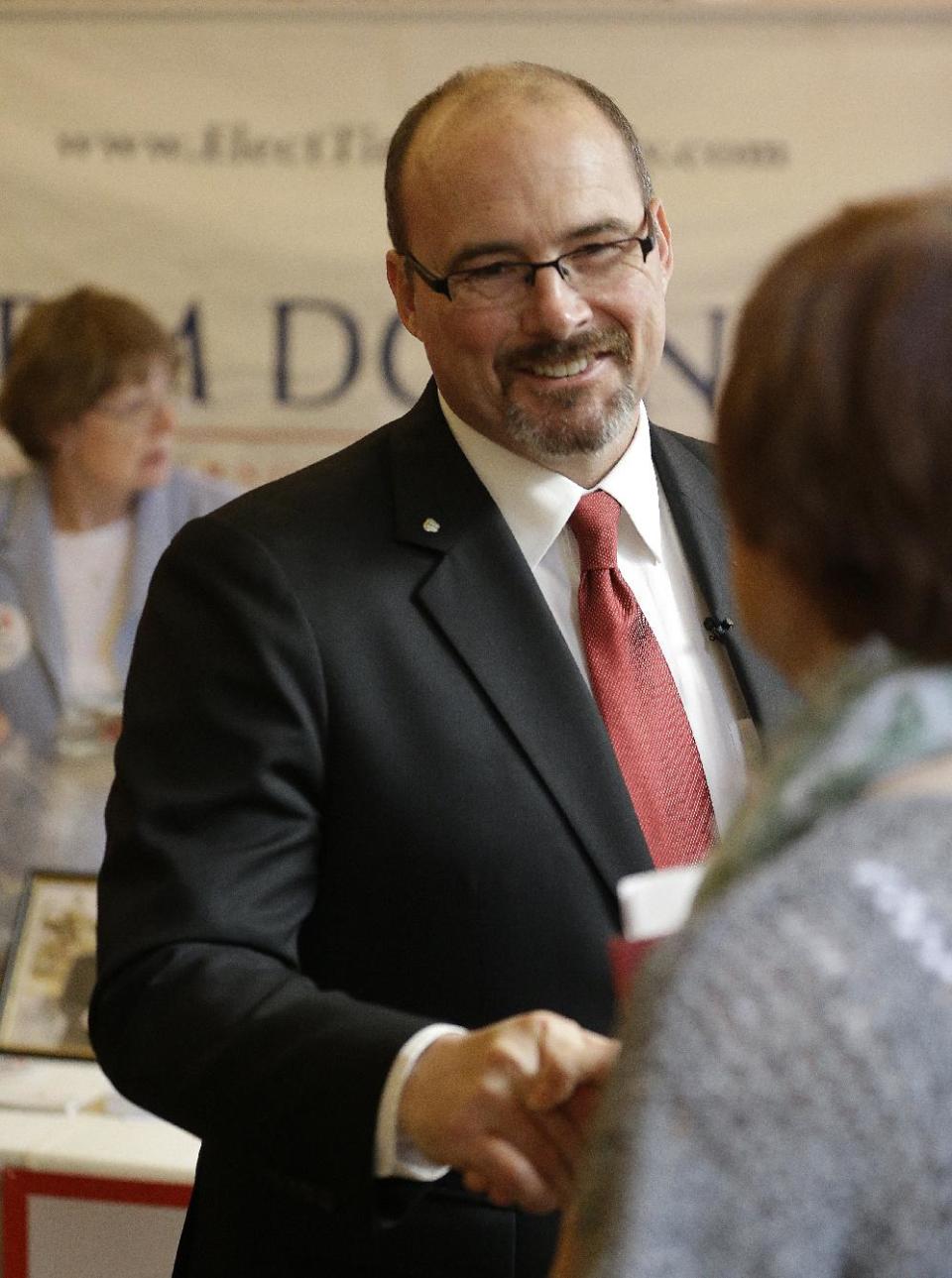 Gubernatorial candidate Tim Donnelly meets with a supporter at the California Republican Party 2014 Spring Convention Saturday, March 15, 2014, in Burlingame, Calif. (AP Photo/Ben Margot)