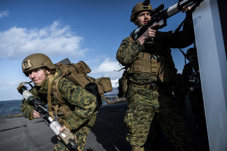 In this image provided by the North Atlantic Treaty Organization, a U.S. marine sprints from cover after landing near Sandstrand, Norway, March 21, 2022, during the Exercise Cold Response 22. (NATO via AP)