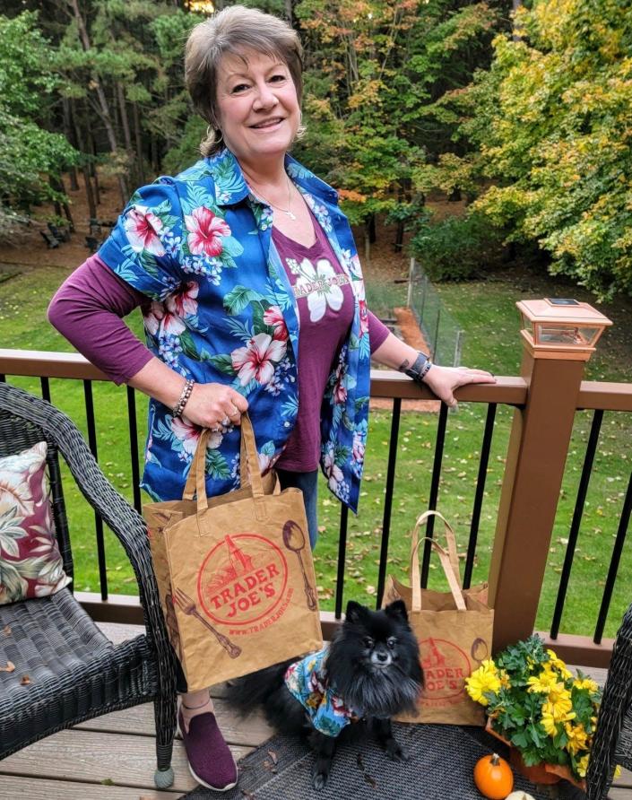 Brenda VanderWege poses for a photo with her dog, Brix.  The duo dressed up as Trader Joe employees for Halloween in 2021.