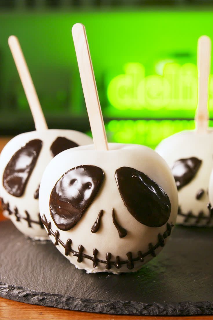 <p>A frightful but sweet treat! Dip Granny Smith apples in white chocolate, then pipe on their spooky faces for the ultimate scare. </p><p>Get the <a href="https://www.delish.com/cooking/recipe-ideas/a23877053/jack-skellington-candy-apples-recipe/" rel="nofollow noopener" target="_blank" data-ylk="slk:Jack Skellington Candy Apples recipe;elm:context_link;itc:0;sec:content-canvas" class="link "><strong>J</strong><strong>ack Skellington Candy Apples recipe</strong></a> from Delish.</p>
