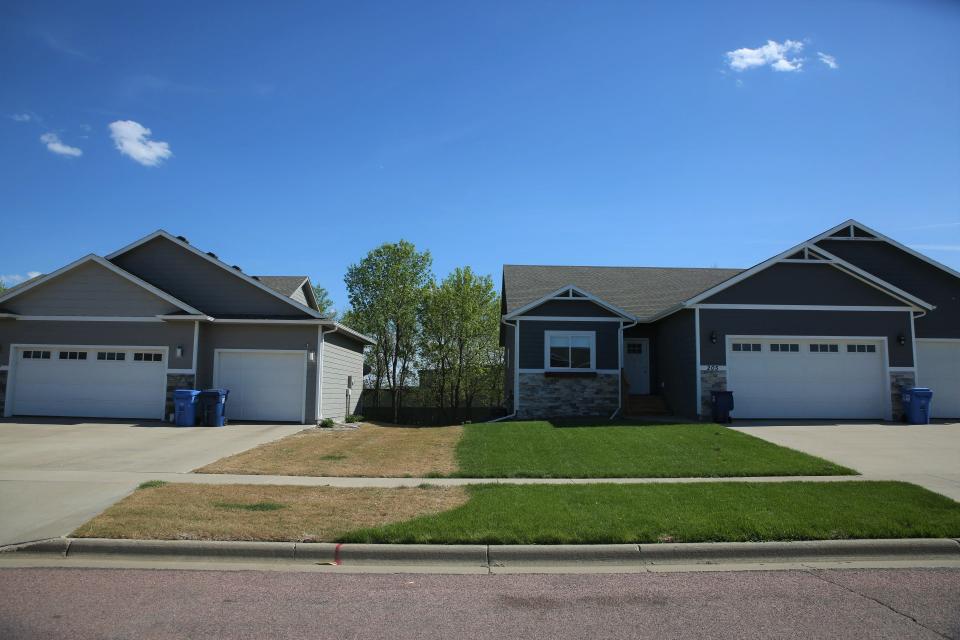 Hazen Vennard's burn lawn contrasts against his neighbor's vivid green yard in Harrisburg on May 16, 2022.