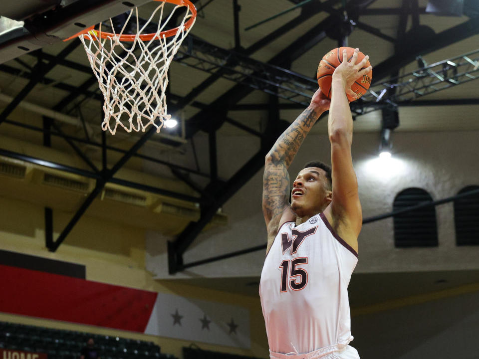 Nov 23, 2023; Kissimmee, FL, USA; Virginia Tech Hokies center Lynn Kidd (15) dunks the ball against the Boise State Broncos in the second half during the ESPN Events Invitational at State Farm Field House. Nathan Ray Seebeck-USA TODAY Sports