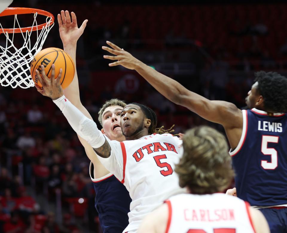 Utah Utes guard Deivon Smith (5) tries to shoot over Arizona Wildcats guard KJ Lewis (5) in Salt Lake City on Thursday, Feb. 8, 2024. | Jeffrey D. Allred, Deseret News