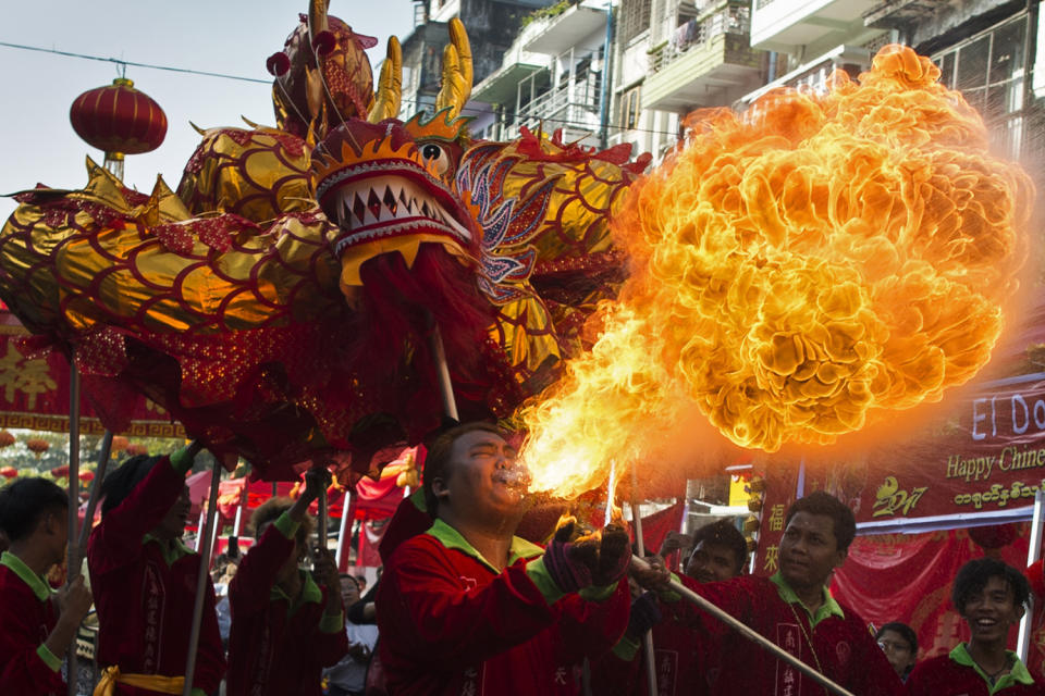 A fire breather blows flames as a troupe performs a traditional dragon dance during the first day of Chinese Lunar New Year in Yangon's Chinatown district on January 28, 2017. (YE AUNG THU/AFP/Getty Images)