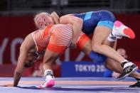 <p>India's Vinesh Vinesh (red) wrestles Sweden's Sofia Magdalena Mattsson in their women's freestyle 53kg wrestling early round match during the Tokyo 2020 Olympic Games at the Makuhari Messe in Tokyo on August 5, 2021. (Photo by Jack GUEZ / AFP)</p> 
