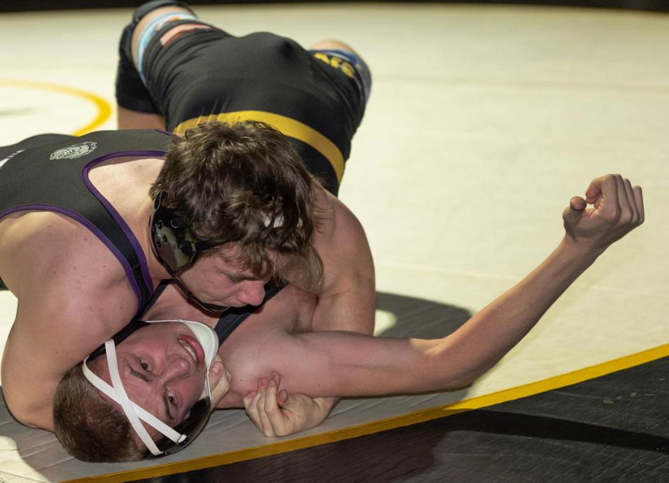 Hudson Skove (top) won his third district championship when he won the District 20 215-pound title.