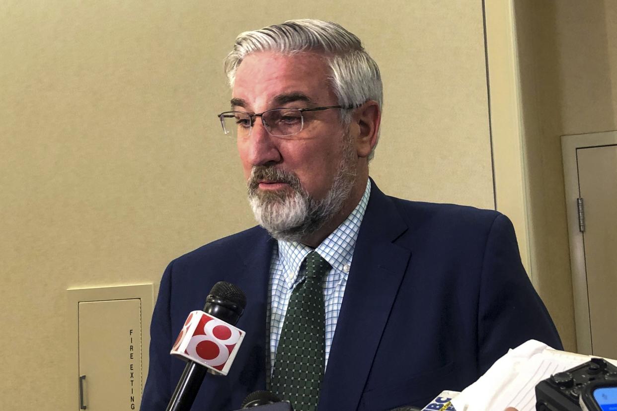 Indiana Gov. Eric Holcomb speaks with reporters at the Indiana Convention Center in Indianapolis on July 12, 2022. 