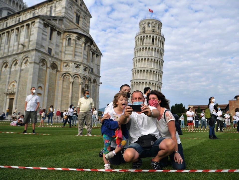 Tourists seen at the tower of Pisa on May 30, 2020.