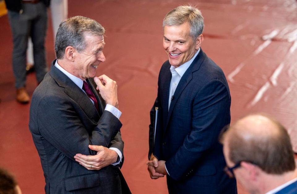 North Carolina Gov. Roy Cooper, left, and Attorney General Josh Stein share a moment backstage as Stein prepares to kick off his campaign for governor during a rally at C.C. Spaulding Gymnasium on the campus of Shaw University in downtown Raleigh on Tuesday, October 10, 2023.