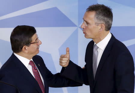 Turkish Prime Minister Ahmet Davutoglu listens to NATO Secretary-General Jens Stoltenberg (R) after a joint news conference at the Alliance headquarters in Brussels, Belgium, November 30, 2015. REUTERS/Francois Lenoir