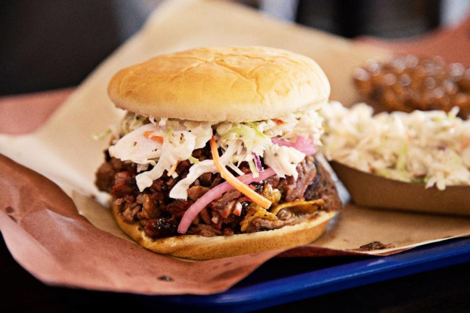 The Porky Brewster at Jon G’s Barbecue on Saturday, June 25, 2022. The sandwich is made up of brisket, pork, Fritos, slaw and topped with pickled onions on a bun.