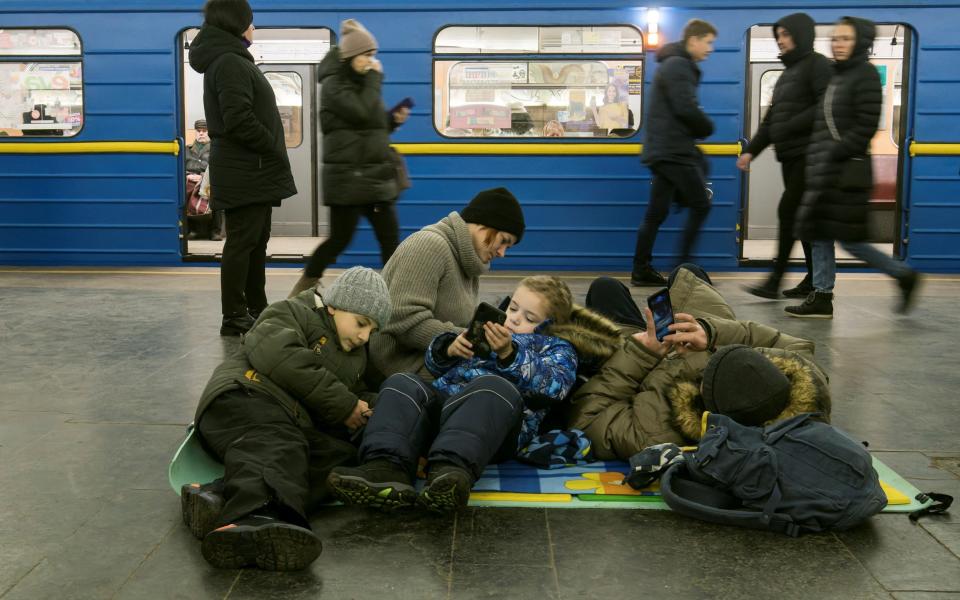 People take shelter inside a metro station during massive Russian missile attacks in Kyiv - REUTERS