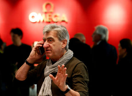 CEO and Chairman of the Board of the Swatch Group Nick Hayek Jr. uses a mobile phone at the Baselworld Watch and Jewellery Show in Basel, Switzerland March 23, 2017. REUTERS/Arnd Wiegmann