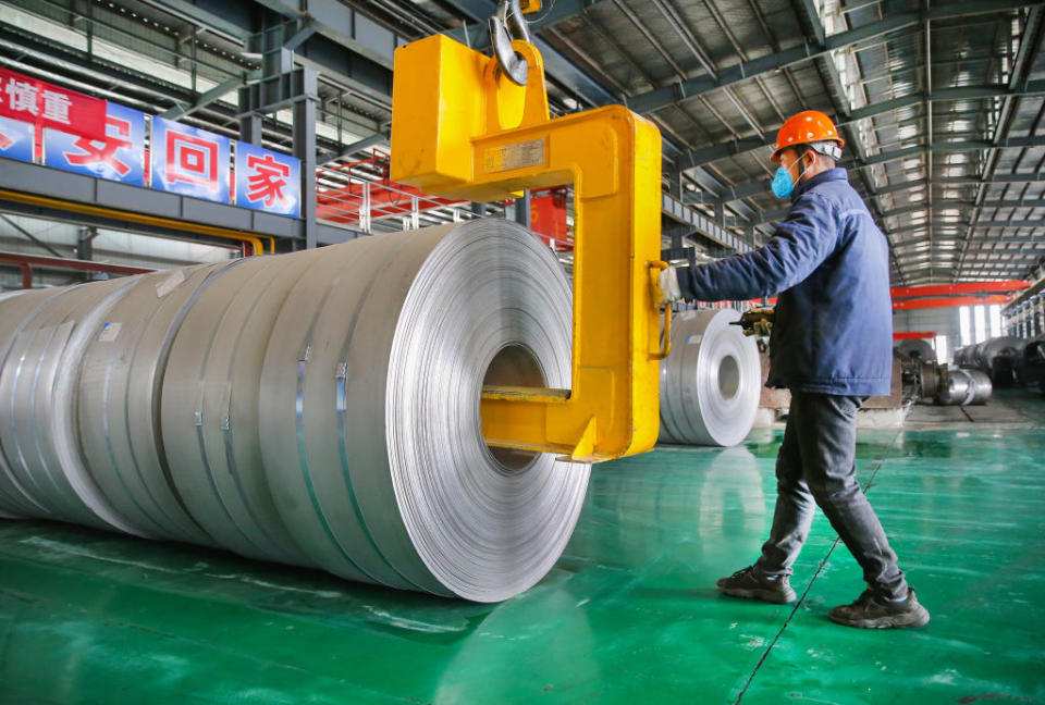 A worker transfers steel coils at a factory of Lianyungang Huale Alloy Group CO., LTD on February 24, 2021 in Lianyungang, Jiangsu Province of China.<span class="copyright">Wang Jianmin/VCG via Getty Images</span>