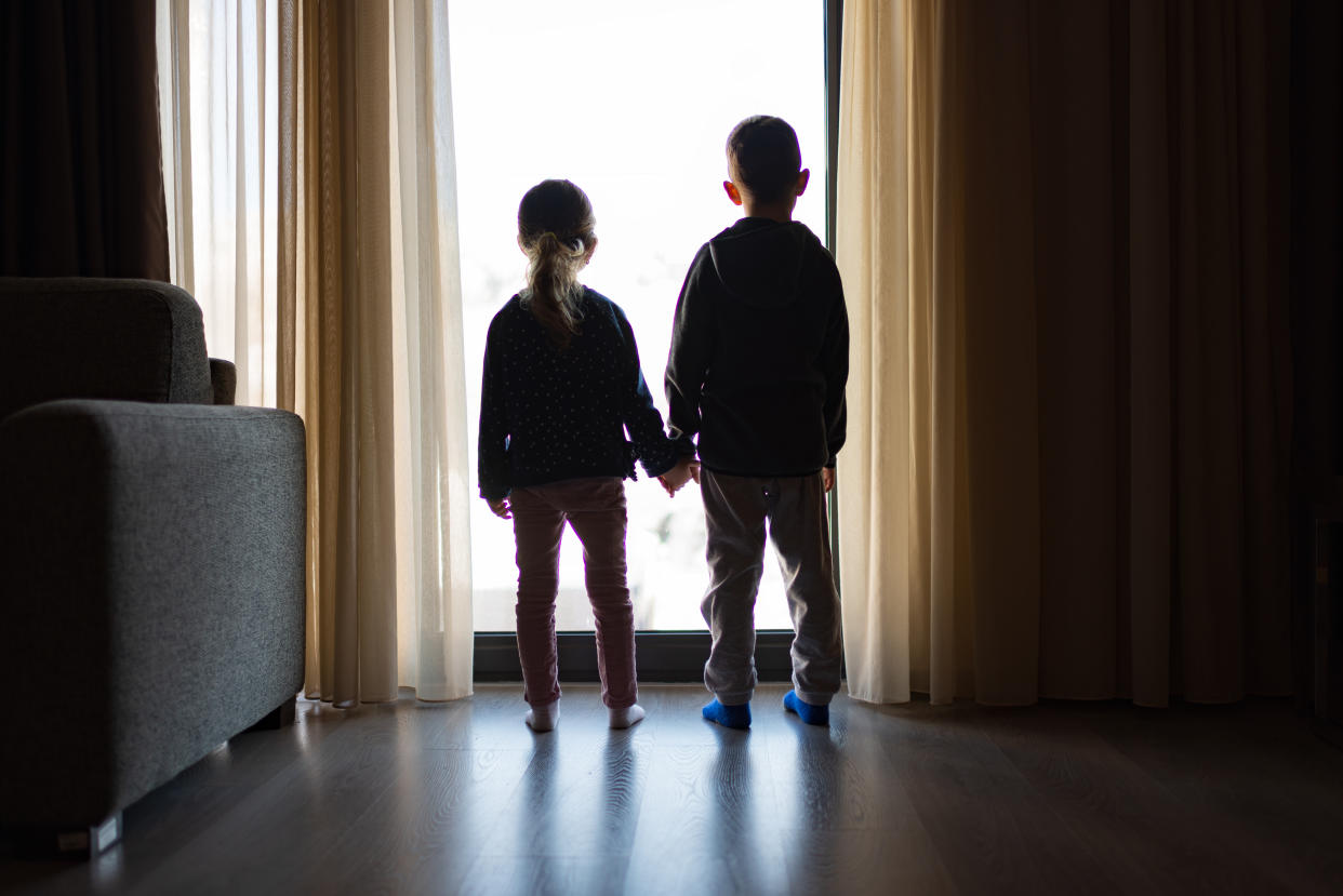 Boy and girl looking through the window.