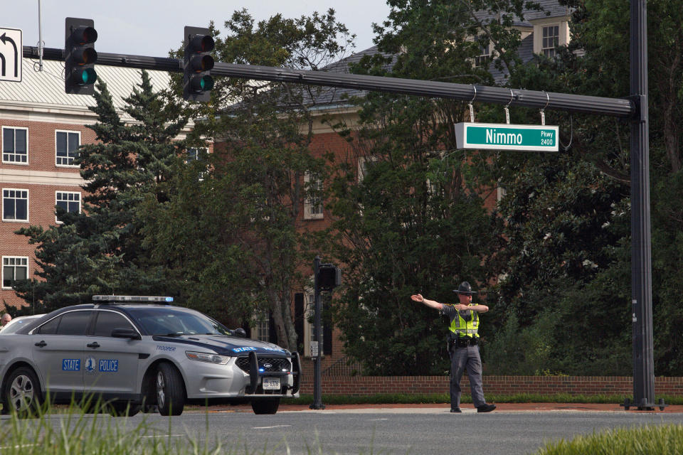 A police officer directs traffic away from the intersection of Princess Anne Road and Nimmo Parkway following a shooting at the Virginia Beach Municipal Center on May 31, 2019, in Virginia Beach, Va. (Photo: Kaitlin McKeown/The Virginian-Pilot via AP)