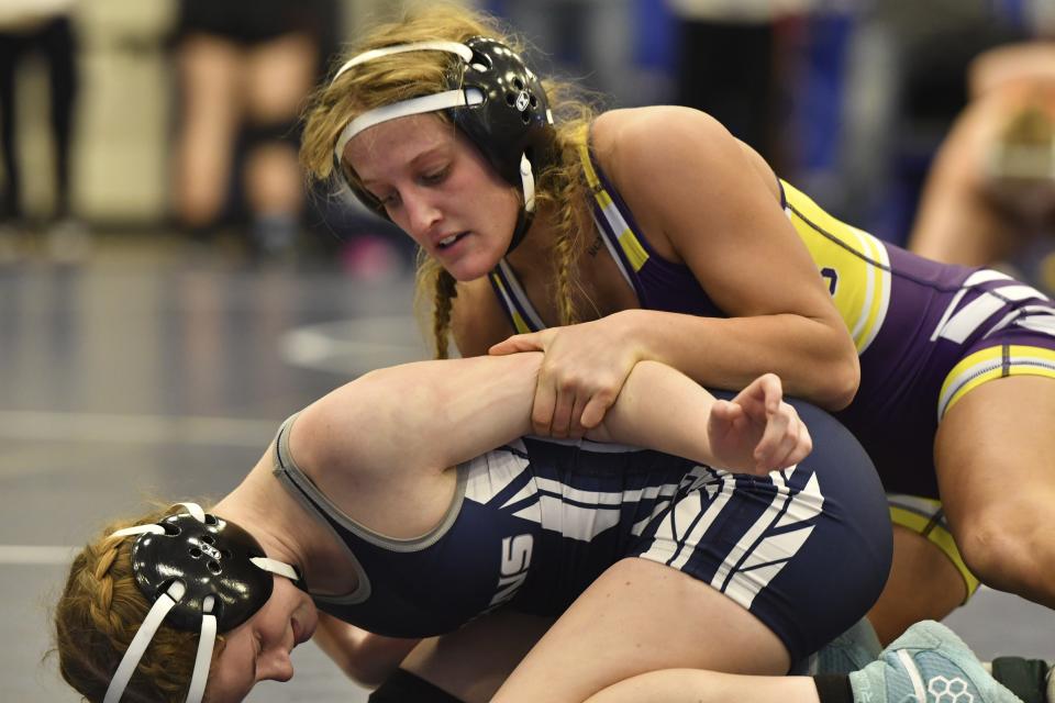 Palisades High School wrestler Savannah Witt, top, competes in a semifinal match during the Southeast Regional wrestling tournament Sunday, Feb. 25, 2024, in Quakertown, Pa. Girls’ wrestling has become the fastest-growing high school sport in the country. (AP Photo/Marc Levy)