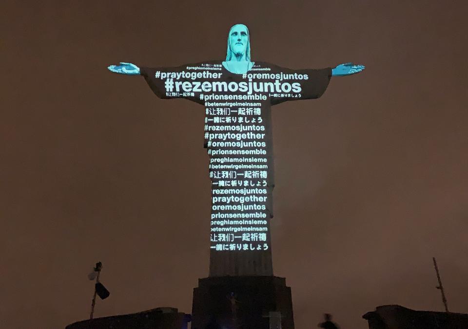 Messages calling for prayer are projected on the Christ the Redeemer statue in Rio on March 18, 2020. (Photo: FLORIAN PLANCHEUR via Getty Images)