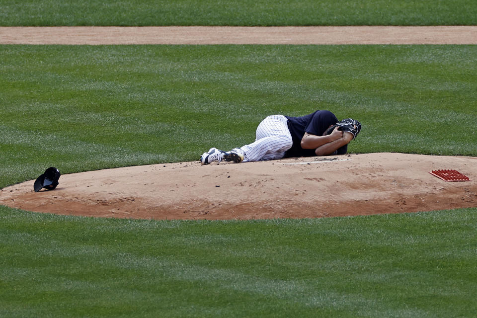 New York Yankees pitcher Masahiro Tanaka lies on the field after being hit by a ball off the bat of Yankees Giancarlo Stanton during a baseball a workout at Yankee Stadium in New York, Saturday, July 4, 2020. (AP Photo/Adam Hunger)