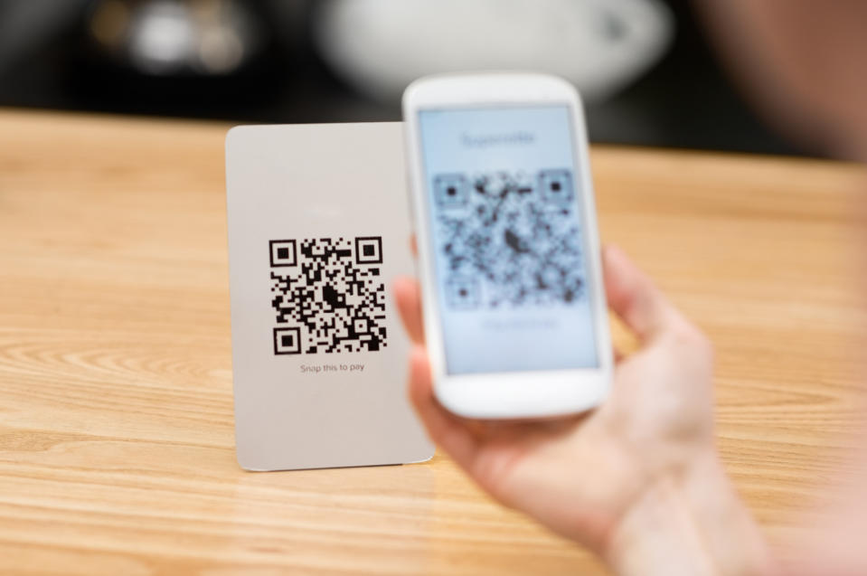 Shopper uses QR code on a smartphone to make a purchase.