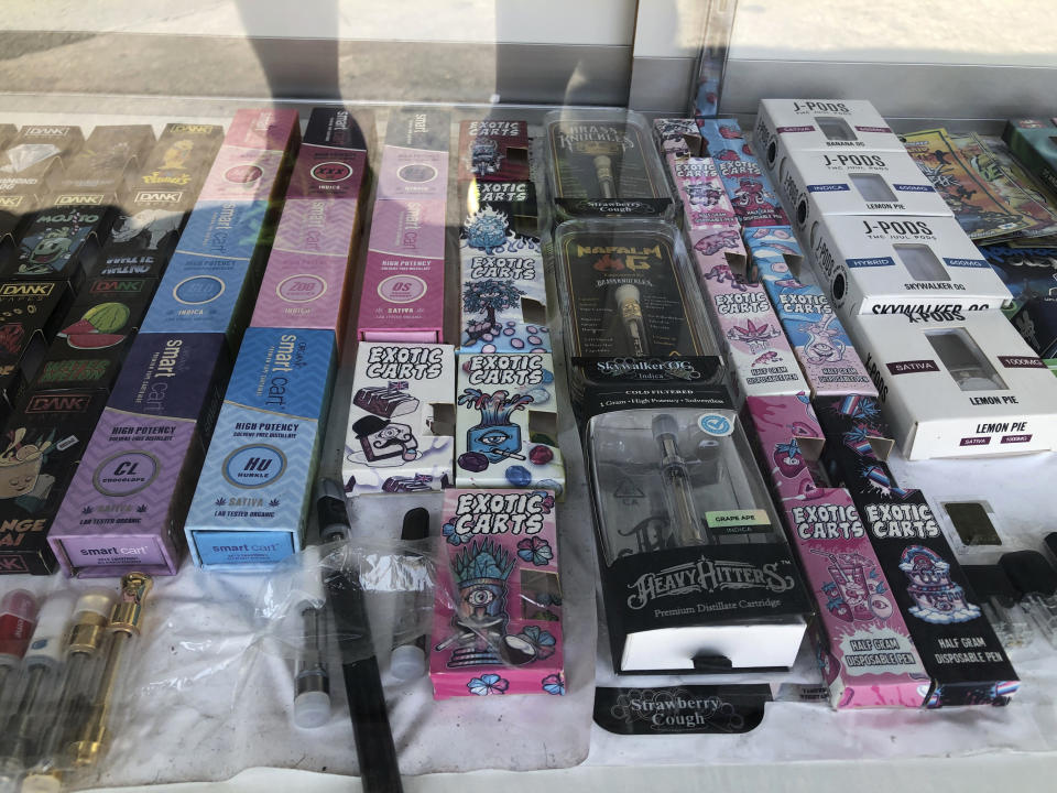 In this Aug. 28, 2019, photograph, counterfeit packaging for popular vape brands like Heavy Hitters can be seen in a display case in a store in downtown Los Angeles. Bootleggers eager to profit off unsuspecting consumers are mimicking popular, legal vape brands, pairing replica packaging churned out in Chinese factories with untested, and possibly adulterated, cannabis oil produced in the state's vast underground market. Health officials are investigating 450 possible cases of vaping-related illnesses in 33 states. (AP Photo/Michael R. Blood)