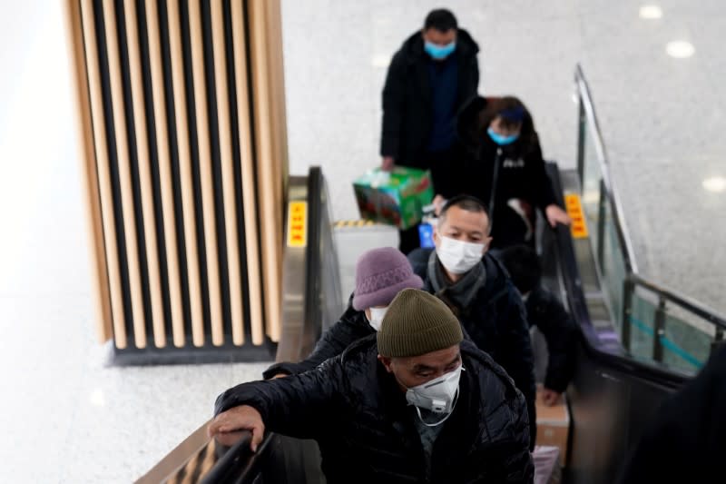 People wearing protective masks are seen at a subway station in Shanghai