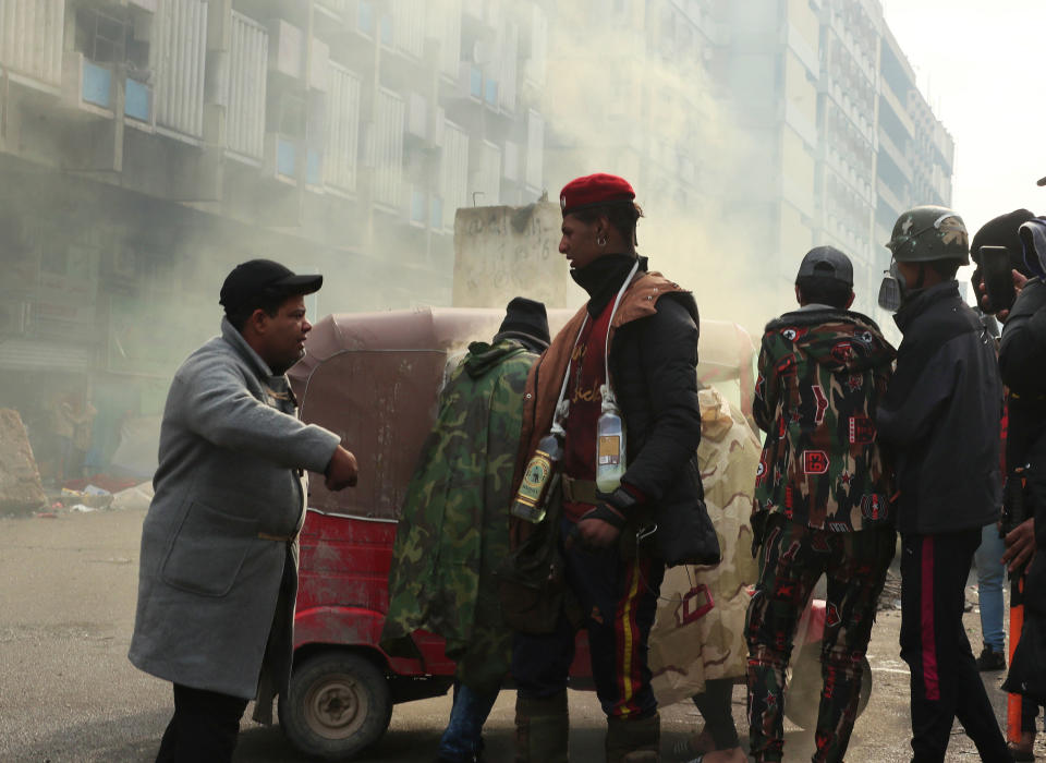 Smoke rise from tear gas fired by security forces during clashes with anti-government protesters in Baghdad, Iraq, Saturday, Jan. 25, 2020. Security forces set fire to anti-government protest tents in the country's south early Saturday and re-opened key public squares in Baghdad that had been occupied by demonstrators for months. (AP Photo/Hadi Mizban)