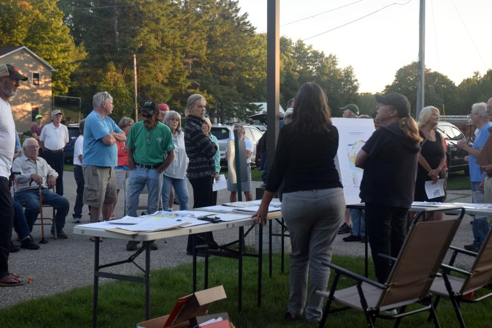LuAnne Kozma and Kim Fary speak to a crowd of about 60 Hayes Township residents about the township master plan and proposed rezoning ordinances on Tuesday, Sept. 20 outside the township hall at 9195 Major Douglas Sloan Road after the township canceled the September planning commission meeting.