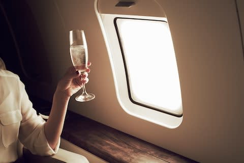 A passenger holding a glass of champagne - Credit: Brand New Images/Flashpop