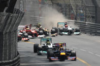 Red Bull Racing's Australian driver Mark Webber leads as Lotus F1 Team's French driver Romain Grosjean (2nd R) and Mercedes' German driver Michael Schumacher (R) collide at the Circuit de Monaco on May 27, 2012 in Monte Carlo during the Monaco Formula One Grand Prix. AFP PHOTO / TOM GANDOLFINITom Gandolfini/AFP/GettyImages