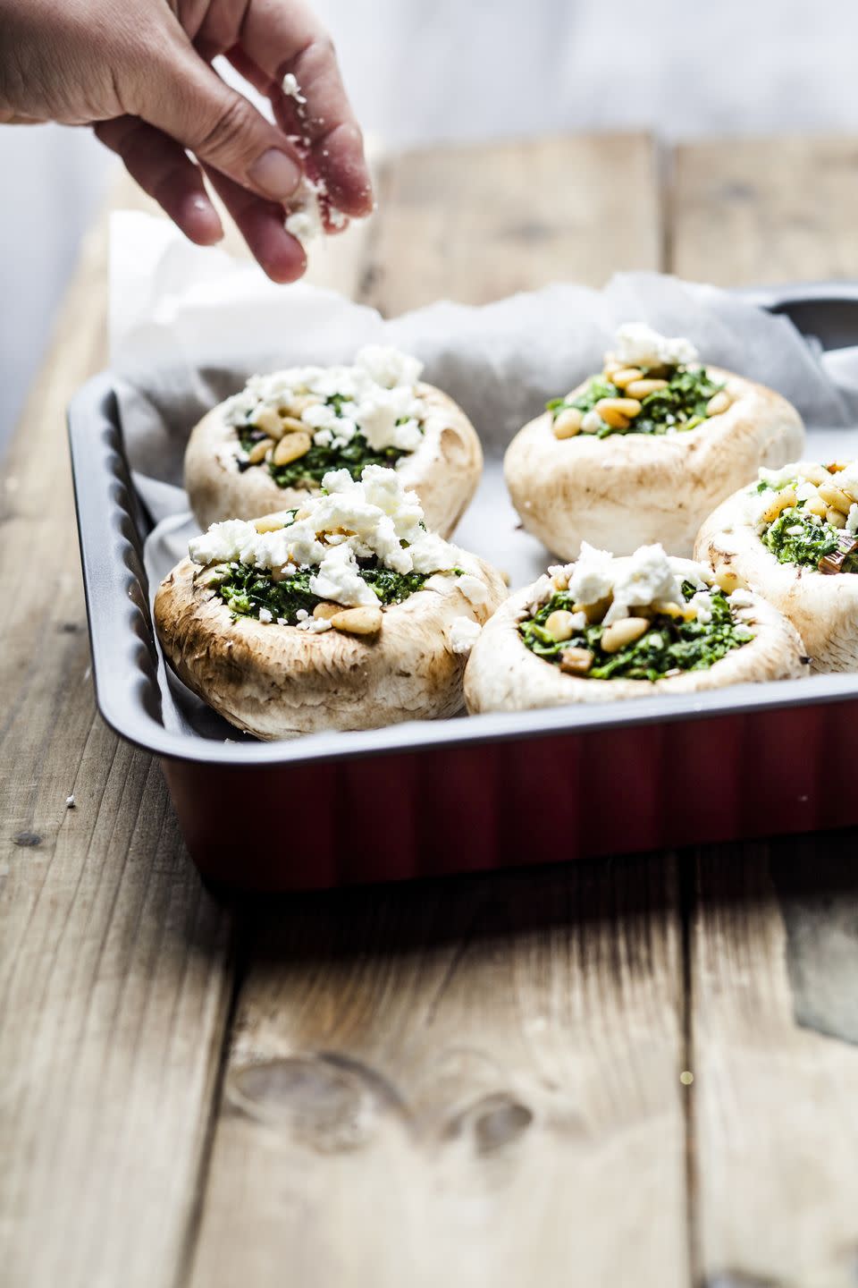 Filled champignons with spinach and feta in gratin dish