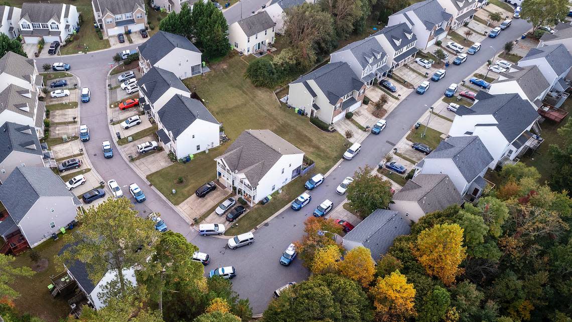 Raleigh Police line the streets while responding to an active shooter situation in the Hedingham neighborhood near the Neuse River Trail in Raleigh, Thursday, Oct. 13, 2022.