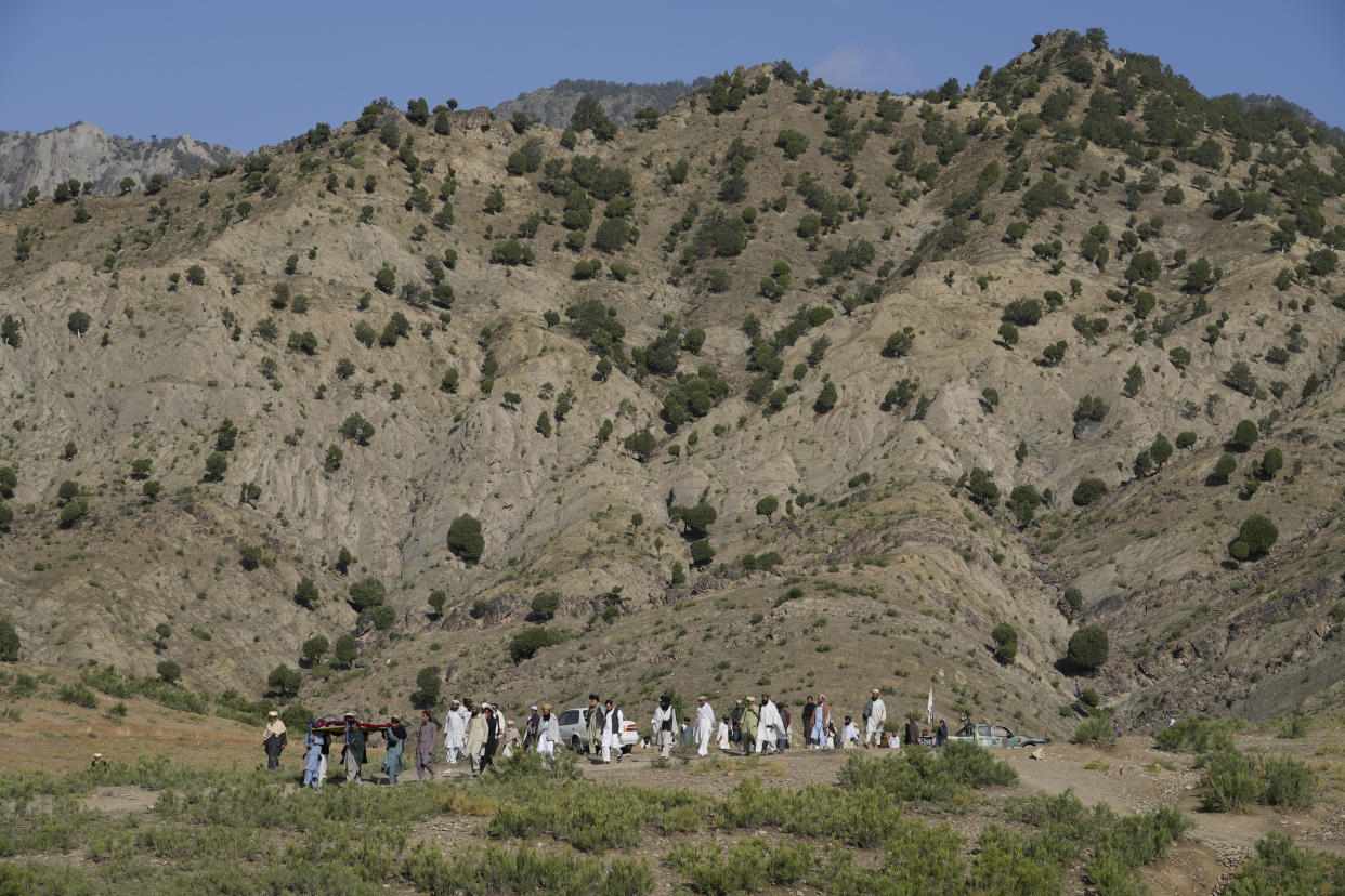 Afghans carry a relative killed in an earthquake to a burial site l in Gayan village, in Paktika province, Afghanistan, Thursday, June 23, 2022. A powerful earthquake struck a rugged, mountainous region of eastern Afghanistan early Wednesday, flattening stone and mud-brick homes in the country's deadliest quake in two decades, the state-run news agency reported. (AP Photo/Ebrahim Nooroozi)