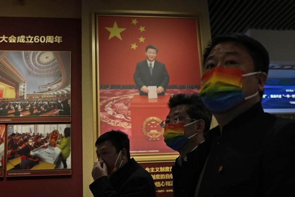 A visitor past by a photo of the Chinese President Xi Jinping casting a vote at the Museum of the Communist Party of China here in Beijing, China, Friday, Nov. 12, 2021. Xi emerges from a party conclave this week not only more firmly ensconced in power than ever, but also with a stronger ideological and theoretical grasp on the ruling Communist Party's past, present and future. (AP Photo/Ng Han Guan)