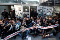 Environmental activists block the entrance of the Ministry of Ecology, Energy and Sustainable Development during a "civil disobedience action" to urge world leaders to act against climate change, in La Defense near Paris, France, April 19, 2019. The slogan reads " Macron, President of polluters" and "scene of climate crime". REUTERS/Benoit Tessier