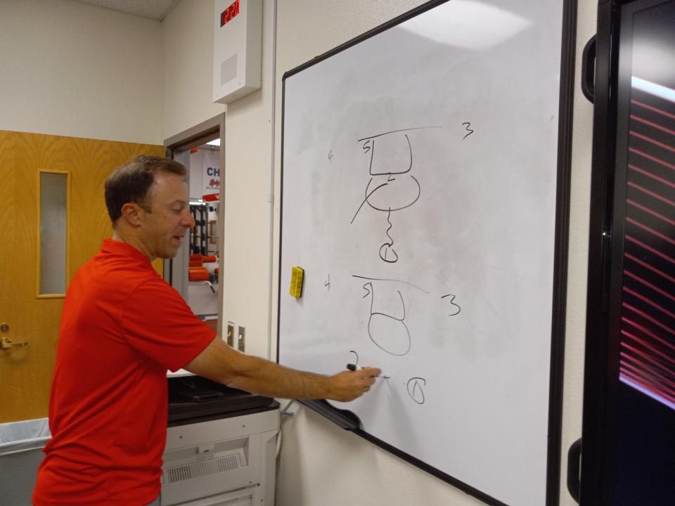 University of New Mexico head men's basketball coach Richard Pitino draws up a play in Artesia on June 26, 2023.