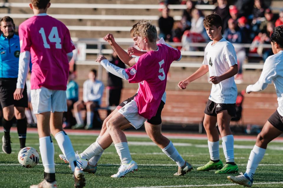 Dover's Arden Klaiber battles New Phila for possession, Saturday, Oct. 15 at Crater Stadium.