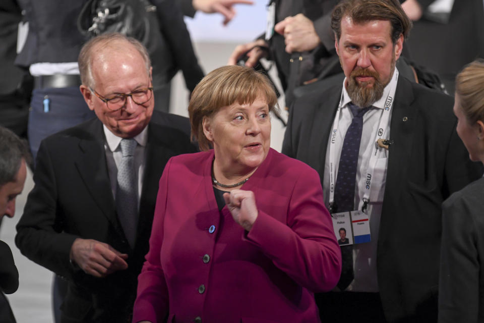 German Chancellor Angele Merkel, center, arrives for a meeting during the Munich Security Conference in Munich, Germany, Saturday, Feb. 16, 2019. (Tobias Hase/dpa via AP)