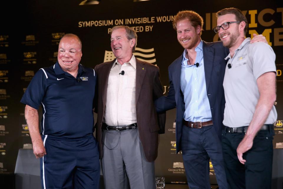 Prince Harry, second from right, and Royal Marine veteran J.J. Chalmers, right, attend Invictus Games Orlando in Orlando, Florida, on May 8, 2016, with Air Force Technical Sgt. Israel Del Toro, left, and former President George W. Bush, second from left.