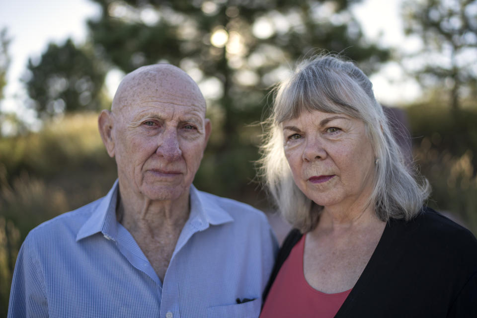 On Tuesday, Sept. 5, 2023, Lonnie Phillips, left, and his wife, Sandy, pose for a portrait at the memorial to the victims of the 2012 mass shooting at an Aurora, Colo., movie theater, in Aurora. Suffering through their own personal loss after a mass shooting in Colorado claimed Sandy's daughter, Jessica Ghawi, in 2012, the couple set out to help other parents like them, traveling to shooting sites around the country. The trip continued for a decade. (AP Photo/David Goldman)