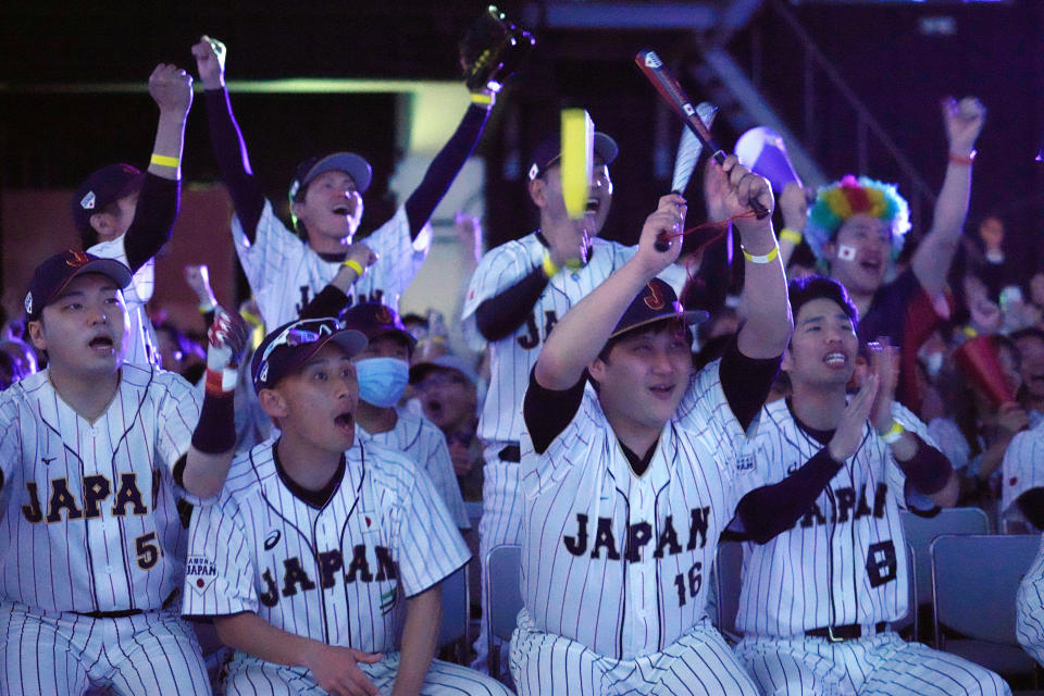 Japan fans react as they watch on a live stream of a World Baseball Classic (WBC) semifinal between Japan and Mexico being played at LoanDepot Park in Miami, during a public viewing event Tuesday, March 21, 2023, in Tokyo. (AP Photo/Eugene Hoshiko)