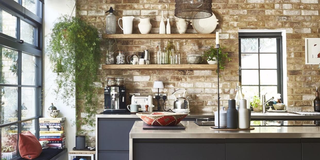 a kitchen with a stone wall