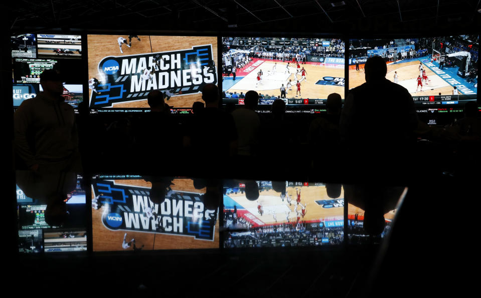 Fans watch the first round of the NCAA college basketball tournament at the Westgate Superbook sports book in Las Vegas on March 15, 2018. (AP/John Locher)