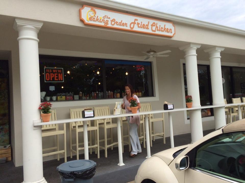 Owner Bridgit Stone-Budd sets up for lunch at The Pecking Order on Sanibel.